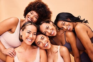 Beauty, diversity and portrait of women happy with makeup for cosmetic skincare isolated in studio brown background. Skin, aesthetic and young friends having discount and edeatogether for self care, dermatology and support, having discounts and deals at wax in the city